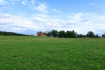 Red house at green lawn. Summer day. Nora, Bergslagen, Sweden.