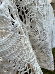 Crochet lace texture with intricate patterns. Suitable as background or for textile design