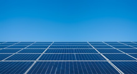 View of solar panels under blue sky. Expansive solar panel array under a clear, vibrant blue sky, showcasing clean energy technology.