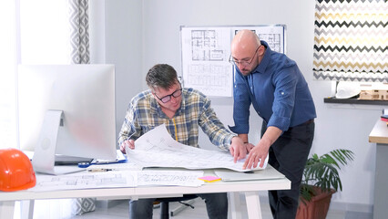 The director of the architectural company coordinates the details of the construction project...
