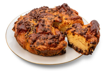 Homemade chocolate chip cake with a slice cut on a white plate with a golden border, isolated 