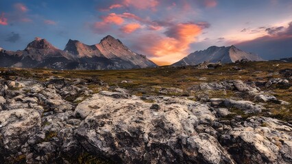 Naklejka premium Golden sunlight streams across a stunning mountain landscape at sunset, with peaks and clouds reflected in the still lake