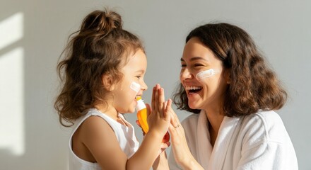 Joyful mother and daughter applying sunscreen indoors with smiling faces. Skincare, family vacation, or everyday parenting content.