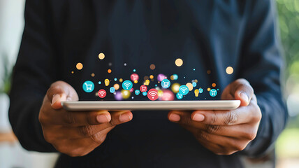 A person holds a digital tablet, showcasing a vibrant cloud of glowing application icons representing a modern digital ecosystem and online services.