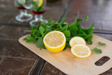 Ingredients for making a mojito at home. Lemon, mint, two glasses with syrup. summer. a refreshing...