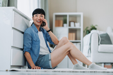 Happy woman talking on mobile phone at home, enjoying relaxing weekend
