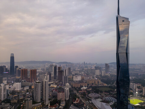 Aerial view of Merdeka 118 pierces the skyline with its sleek, reflective facade amidst the urban sprawl, Kuala Lumpur, Kuala Lumpur, Malaysia.