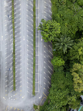 Aerial view of stark asphalt meeting lush greenery, a study in contrasts under the Malaysian sun., Kuala Lumpur, Kuala Lumpur, Malaysia.