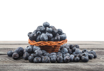 Blueberries on wooden table isolated on white background.