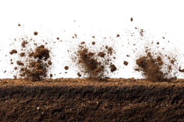 Soil explosion; dirt particles erupting from a dark brown earth layer