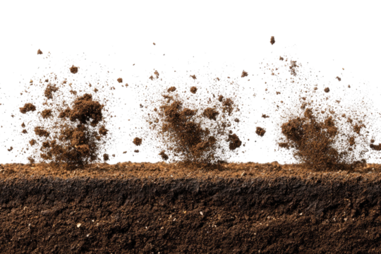Soil explosion; dirt particles erupting from a dark brown earth layer