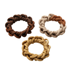 Obraz premium Three circular hair ties, layered in brown, beige, and light brown tones. They feature a braided or woven design