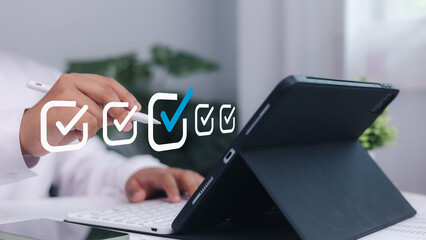 Checkmark concept, Businessman using digital pen to check task list on tablet screen. Concept of productivity, digital planning, project management, and smart office tools.