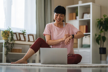 Happy japanese woman use laptop for video call starting online yoga lesson