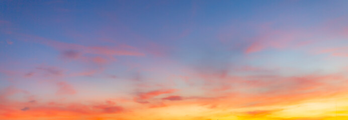 Obraz premium Colorful sky and clouds backdrop in the morning,Beautiful Vivid sky painted by the sun leaving bright golden shades.