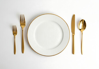 elegant table setting with gold cutlery and white plate on clean dining background
