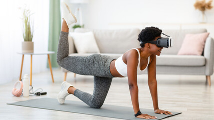 Black Sporty Woman Wearing VR Headset Exercising During Virtual Workout In Digital Gym Training At...