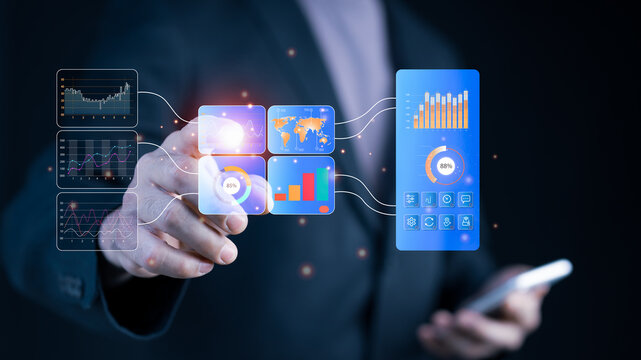 Businessman interacting with futuristic holographic dashboard showing global business data, charts, graphs, and world map for financial analysis, mobile management, and strategic data-driven planning