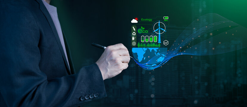 Businessman using stylus with holographic display showing world map, wind turbine, batteries, eco icons, representing global sustainability, green technology, renewable energy, eco-friendly innovation