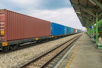 Obraz premium Industrial cargo train with stacked containers on railway platform, symbolizing global freight systems, the economy backbone, distribution networks, and heavy-duty transportation services