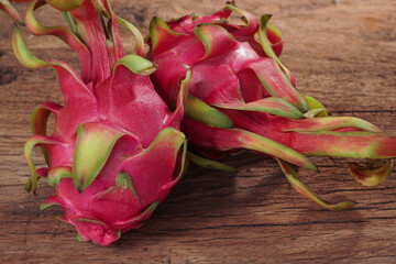 Red-fleshed pitaya or Dragon Fruit. Tropical fruits healthy dragon fruits. Sliced dragon fruit on plate, wooden background, healthy food.