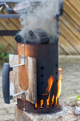 Charcoal Chimney Starter with Flames and Smoke