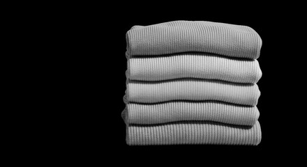 Stack of folded cozy sweaters isolated on transparent background