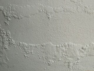 Rough cement wall texture with gradient lighting and soft focus.