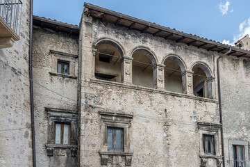 arched loggia on medieval stone facade at historical hilltop little village, Santo Stefano di...