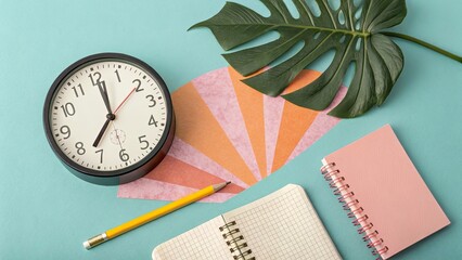 Black clock yellow pencil pink notebook green leaf image