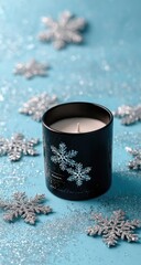 A black candle sits atop a light teal background, surrounded by silver snowflakes and glitter