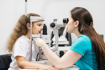 An ophthalmologist does an eye examination, working in a modern clinic with professional equipment....