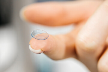 Close-up of a contact lens for vision on a fingertip. Concept clarity, precision, vision correction