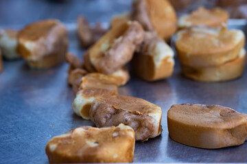 Traditional Indonesian street snack, pukis cake, freshly baked, placed on a metal tray, is ready to...