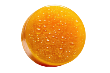 Close-up of a round, orange confectionery.  Water droplets are clustered on the surface