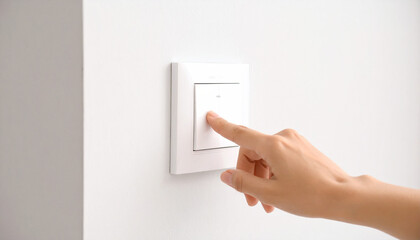 Powering Up: A close-up captures a moment of decisive action as a hand reaches out to flip a light switch, illustrating the power of activation and control within a modern domestic setting.