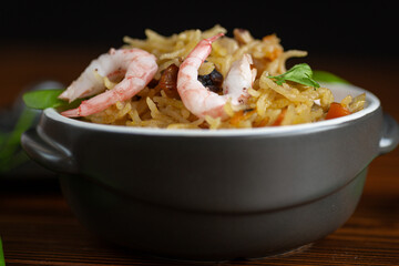 Black background and dish with shrimps, vegetables and rice