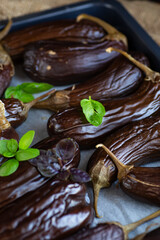 baked eggplants with basil lie on a baking sheet