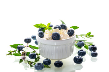 Healthy breakfast cottage cheese with blueberries on a white background