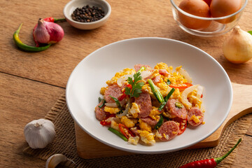 Stir Fried Fermented Pork Sausage with Eggs and chillies in a plate.(naem pad kai)