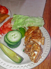 Fried lionfish with vegetables dish (pterois volitans) cooking presentation