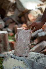 A young man holds an Old brick