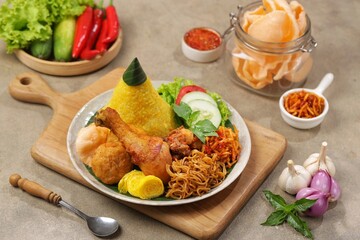 Nasi Kuning. Yellow rice is a typical Indonesian food. This food is made from rice cooked with...