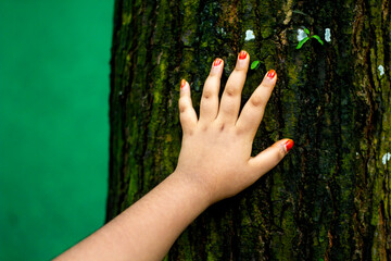 A young man put his hand on the tree