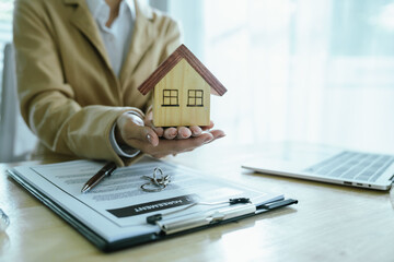 The real estate sales agent will hand over the keys and sign the contract, which symbolizes the...