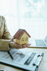 The real estate sales agent will hand over the keys and sign the contract, which symbolizes the...