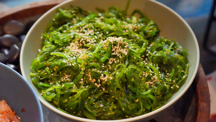 A healthy green vegetarian meal of fresh broccoli spinach soup with parsley herb in a white bowl