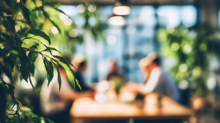 Green leaves frame business people having a meeting in a blurred modern office with natural light and plants, creating a calm and productive atmosphere