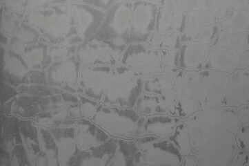 gray background, photo shows texture of concrete wall and cracks in plaster