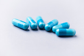 Amino acids capsules on bright background. Soft focus. Close up. Copy space.
